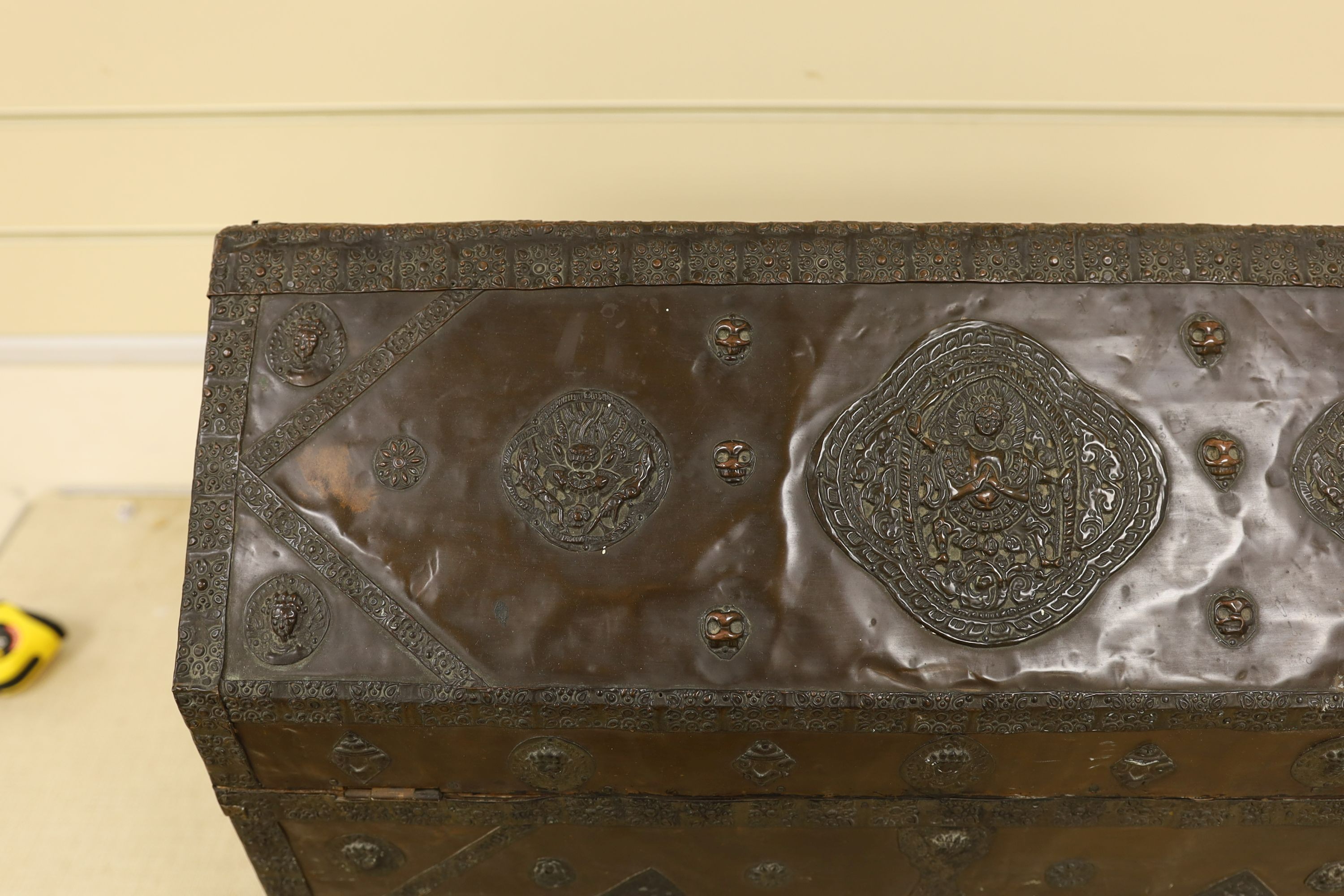 A Tibetan copper repousse-work casket, 20th century, 65cm wide, 49.5cm